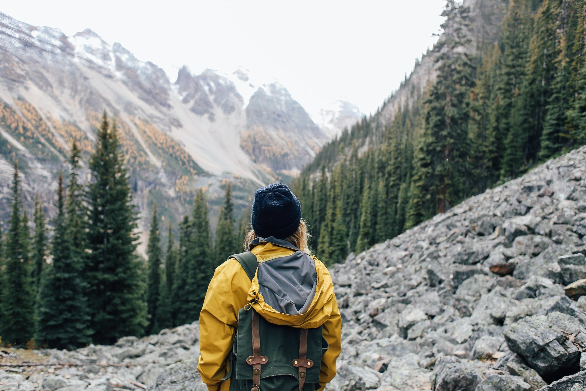 traveler standing on stones in mountainous terrain. smart money bro
