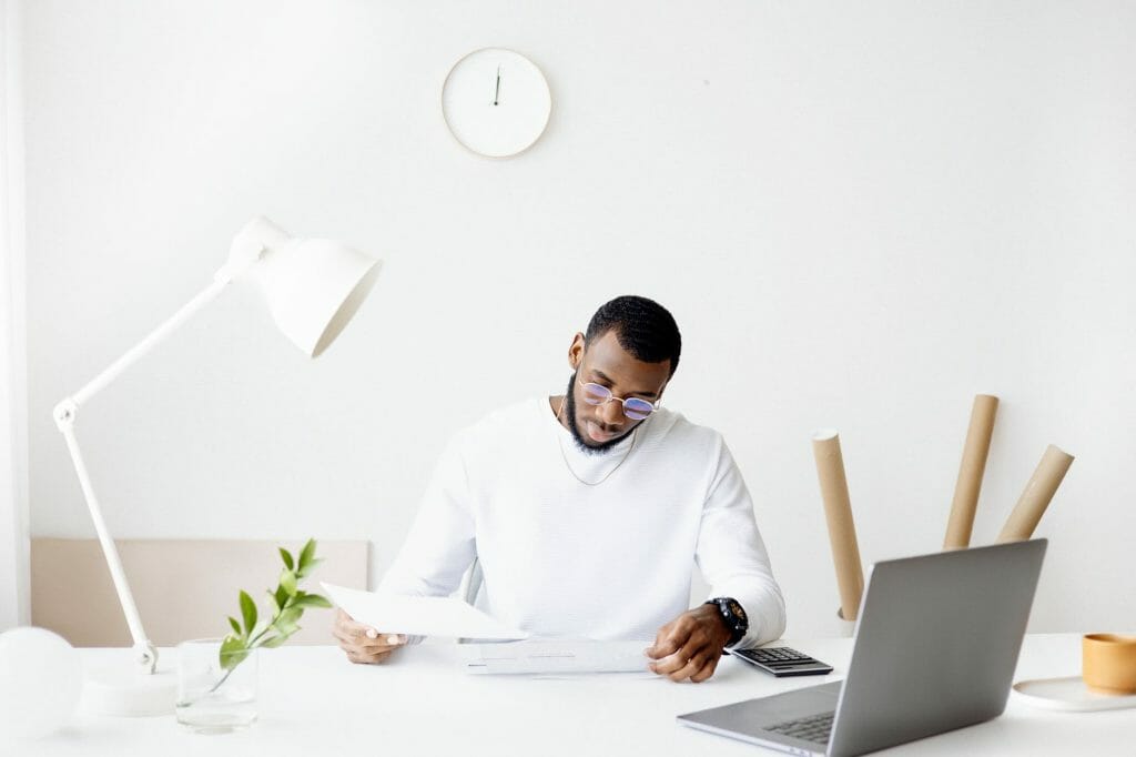 person smartphone desk laptop