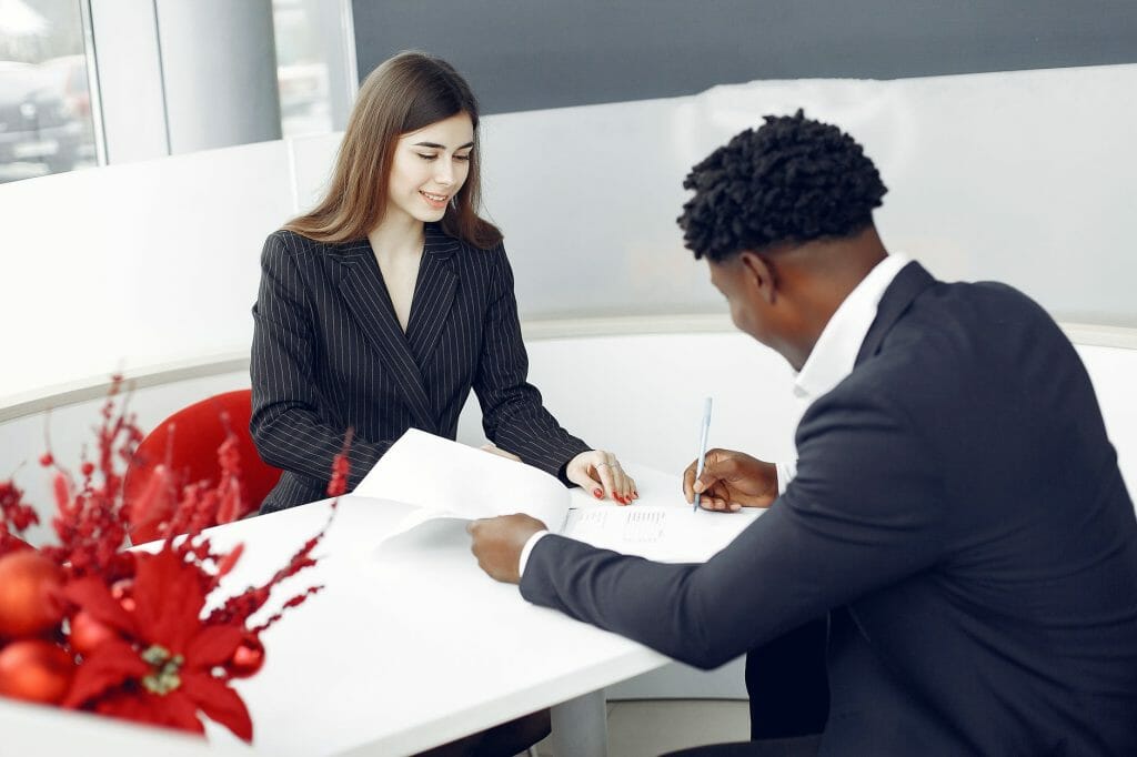 diverse buyer and agent signing papers