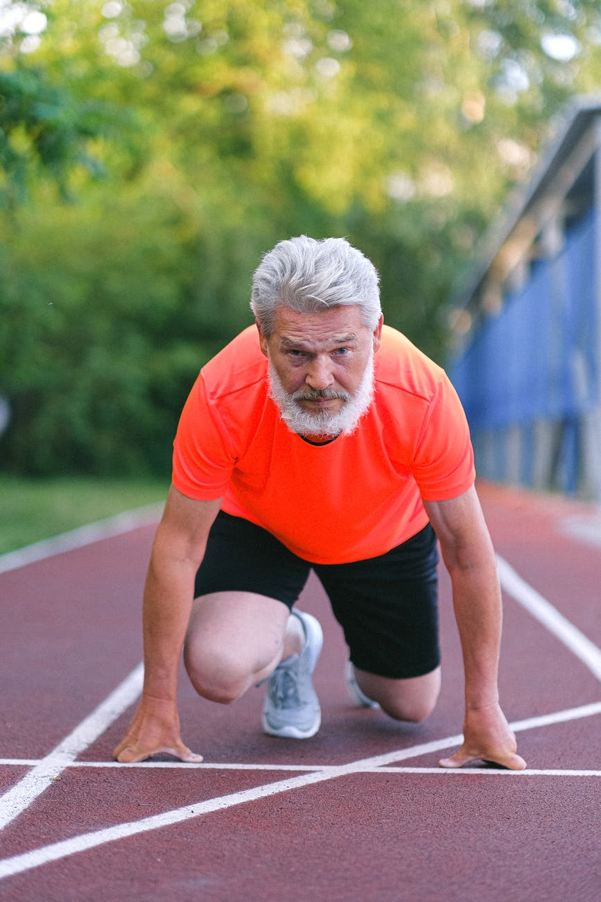 strong senior sportsman preparing for competition in racing, smart money bro