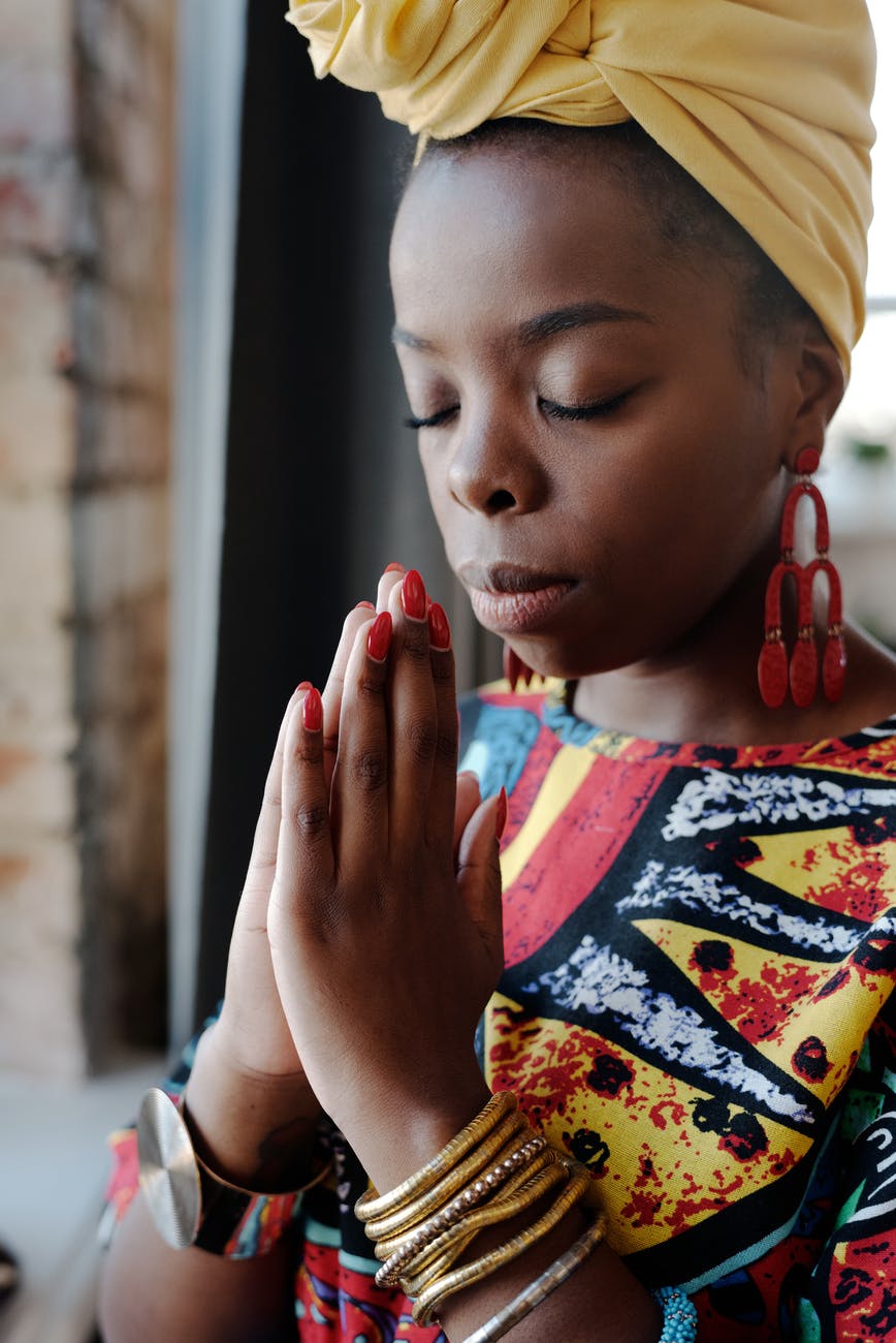 close up photo of woman praying, smart money bro